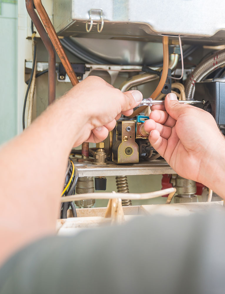 A local heating technician servicing a heating unit in Myrtle Beach.